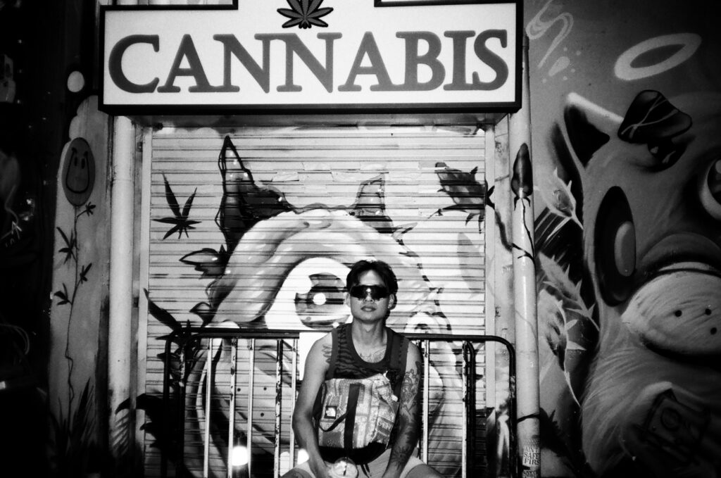 Black and white image in front of a cannabis sign.
